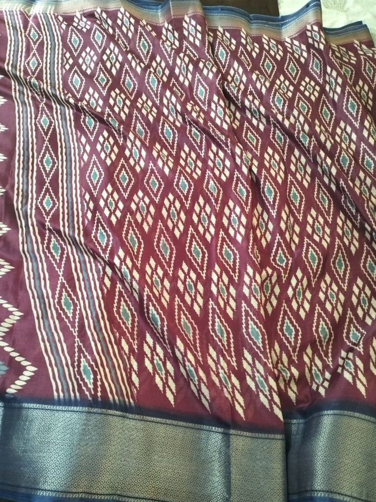 Maroon geometric design semi silk saree with rich blue border