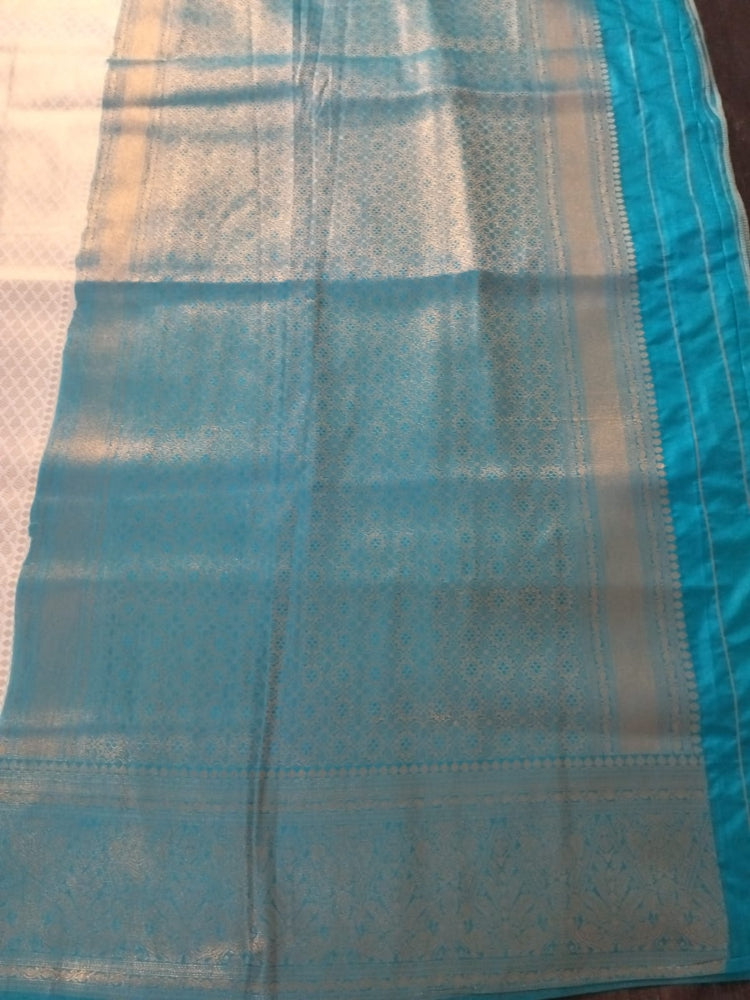 Pearl white with sea green border semi silk saree with golden self design