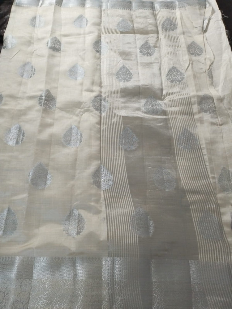 White semi benarasi silk with silver base pallu and big buttas