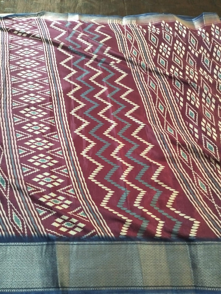 Maroon geometric design semi silk saree with rich blue border