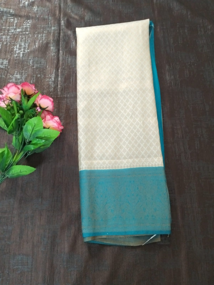 Pearl white with sea green border semi silk saree with golden self design
