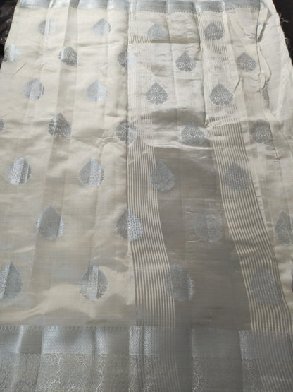 White semi benarasi silk with silver base pallu and big buttas
